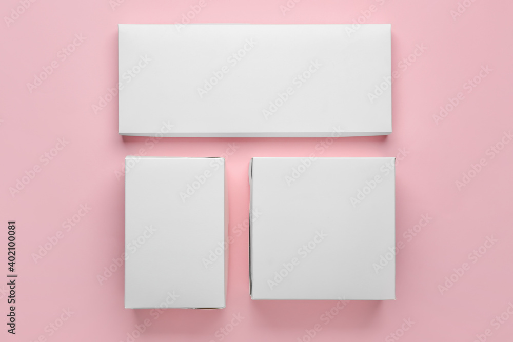 Blank cardboard boxes on color background