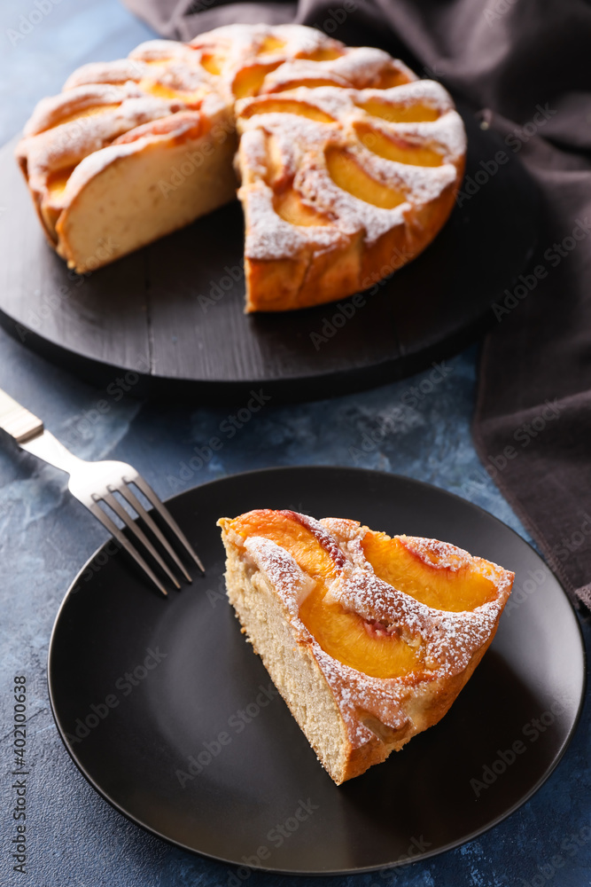 Plate with piece of tasty peach pie on table