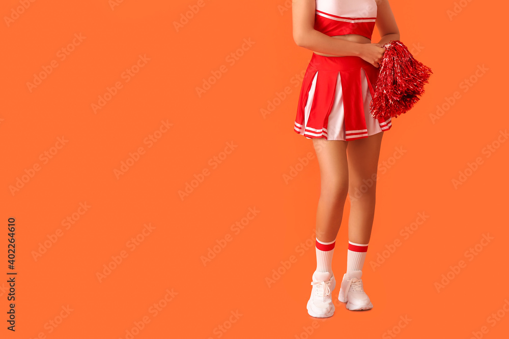 Beautiful young cheerleader on color background