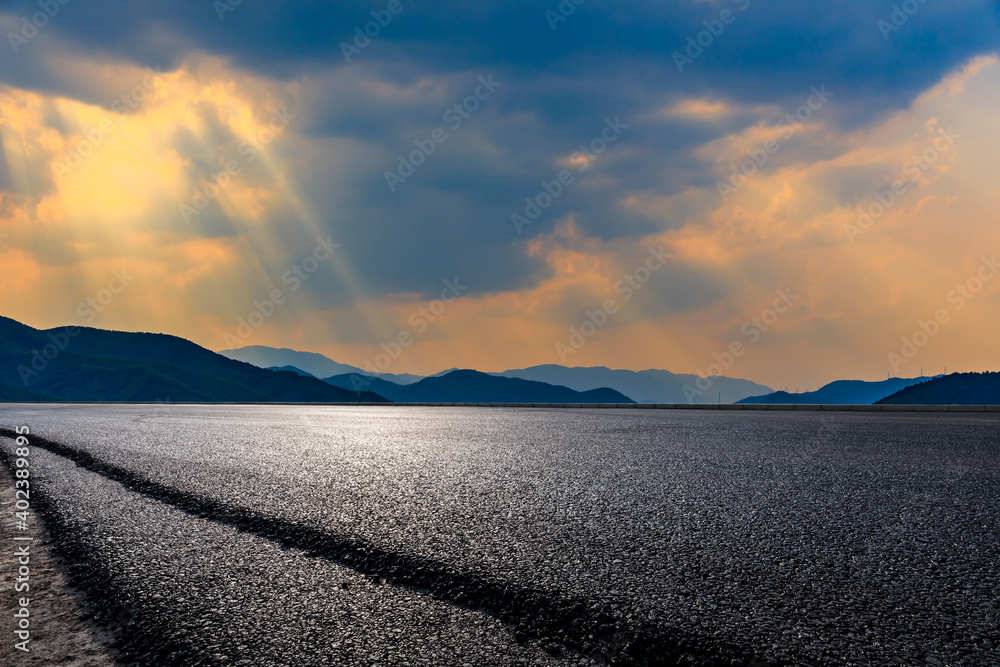 Asphalt road and mountain at sunset.Road and mountain background.