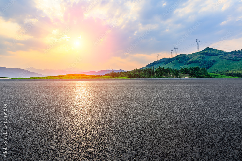 Asphalt road and mountain with tea plantation at sunset.Road and mountain background.