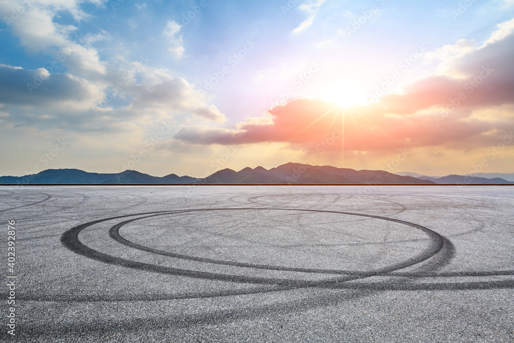 Asphalt road ground and mountain at sunset.Race track road and mountain background.