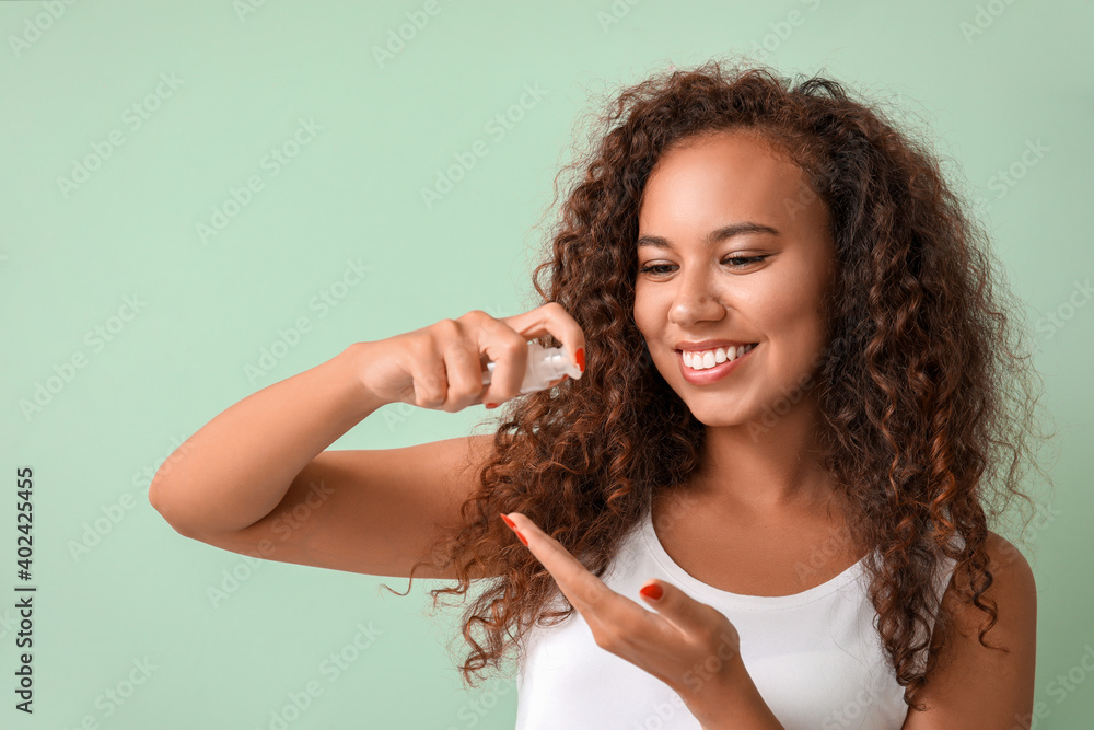 Beautiful young woman with cosmetic oil on color background