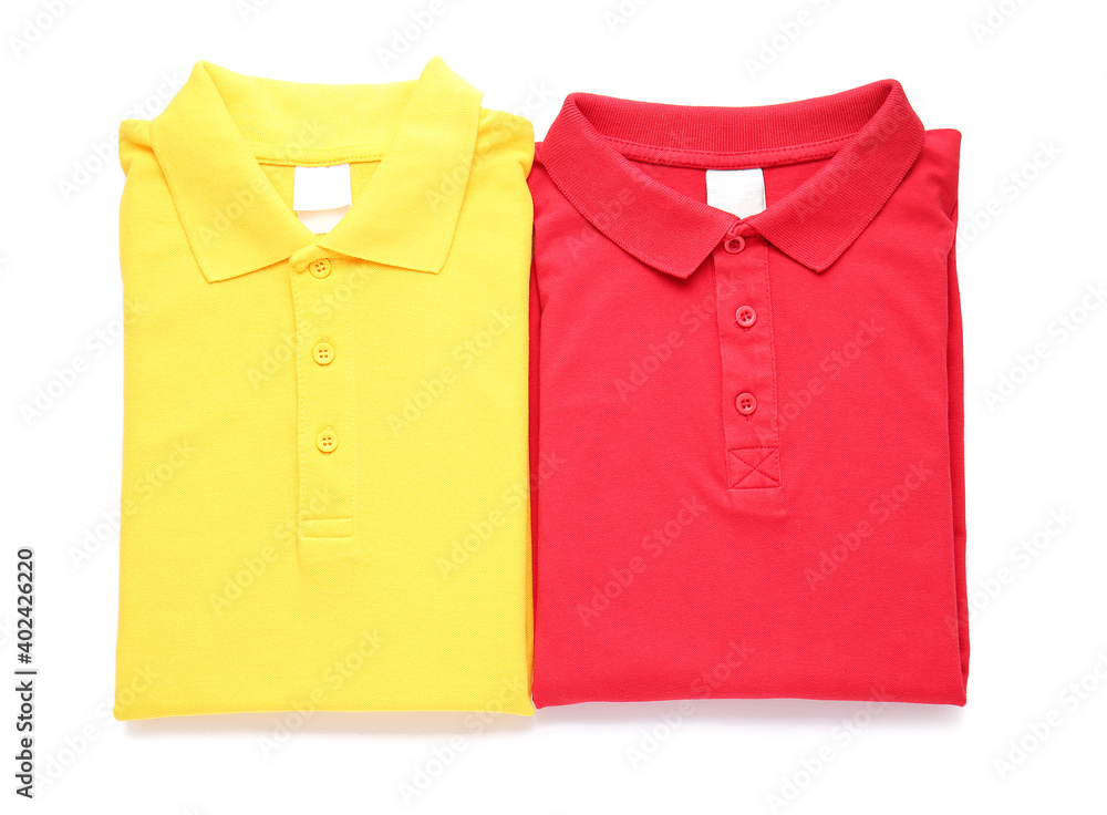 Folded polo shirts on white background