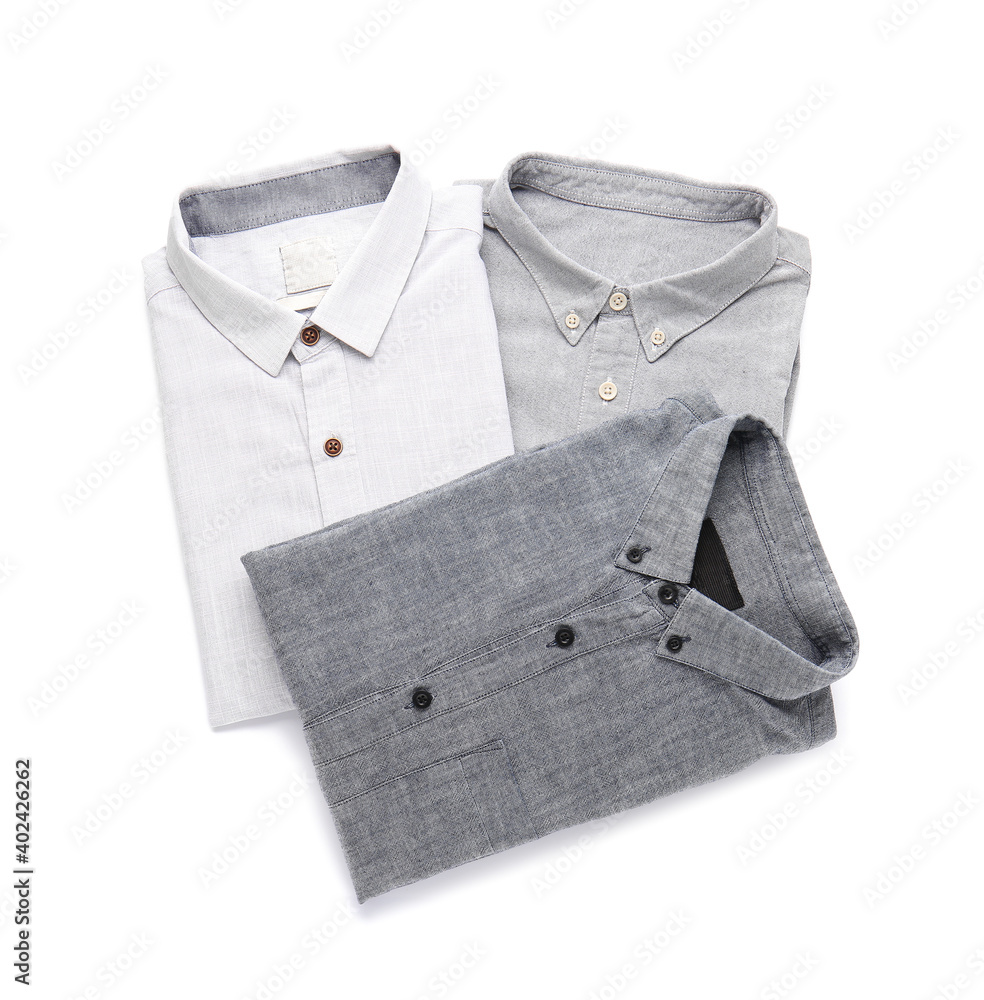 Folded male shirts on white background