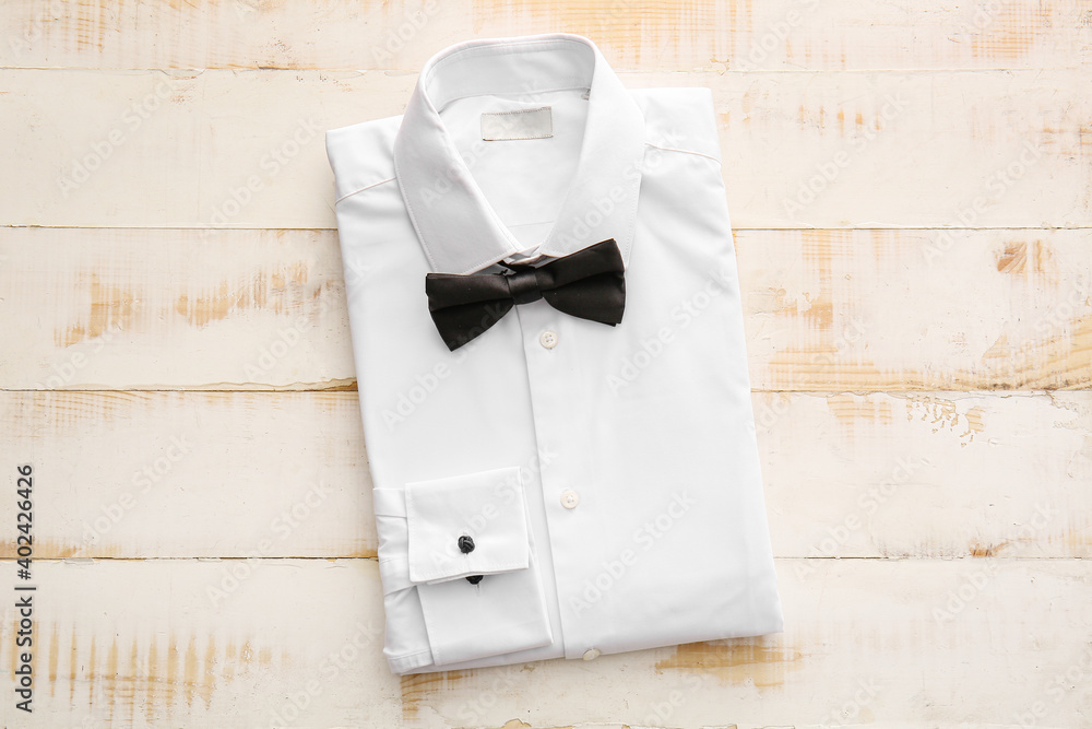 Folded male shirt on wooden background