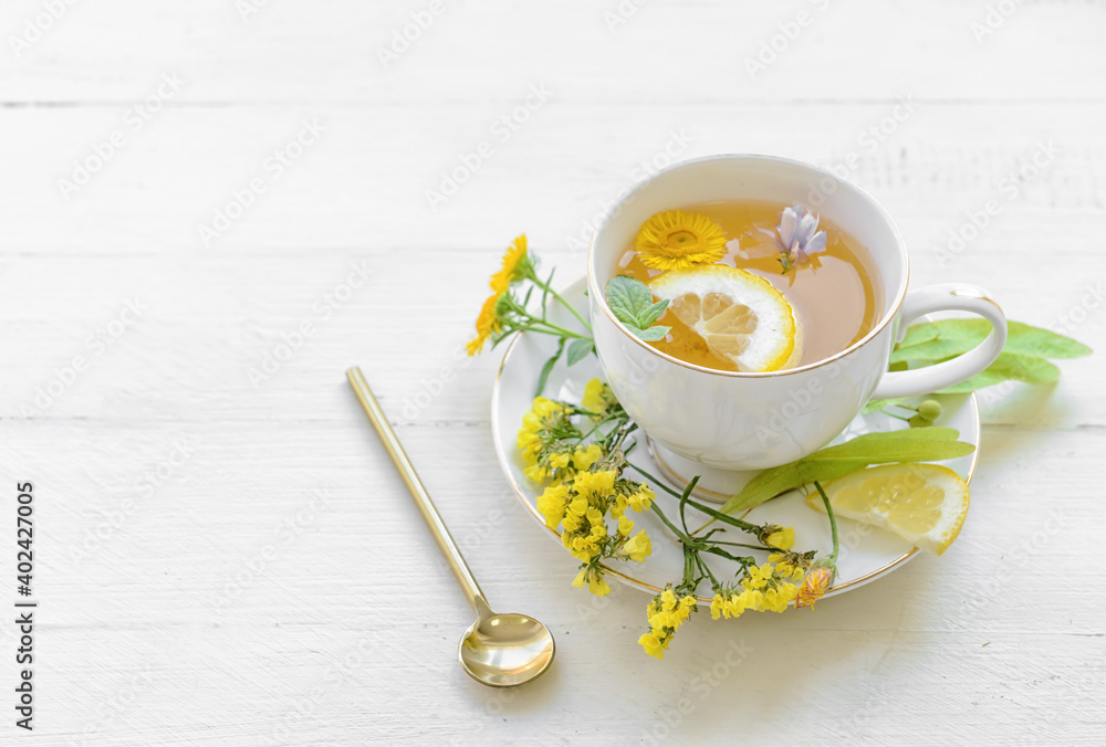 Cup with floral tea on light background