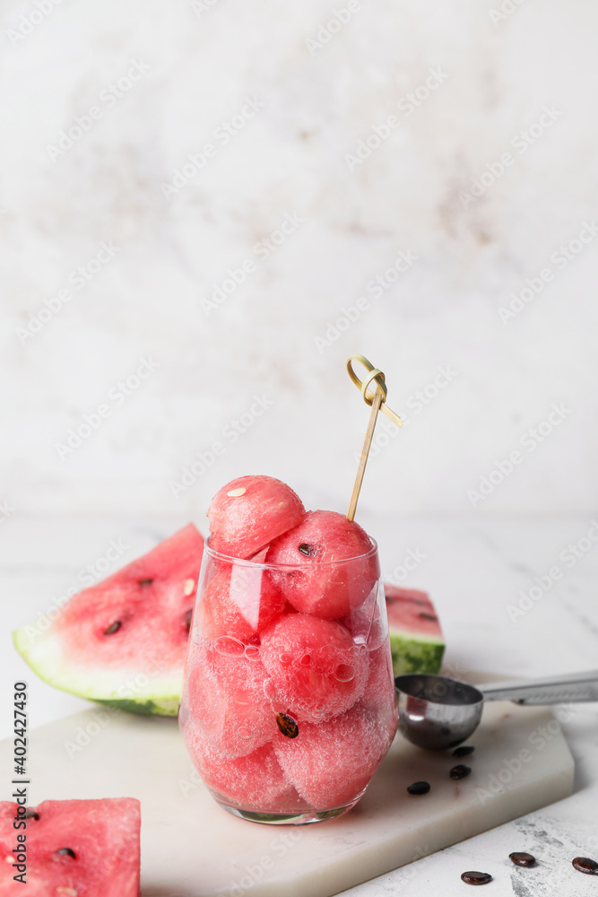 Tasty watermelon balls in glass on table