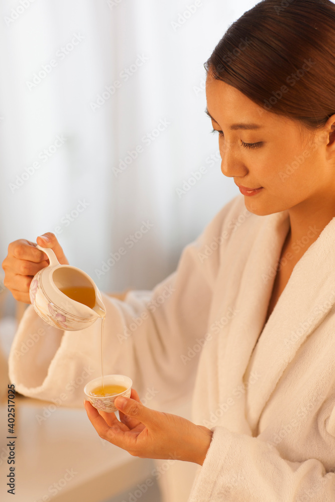 A woman sitting at a table with a cup of coffee