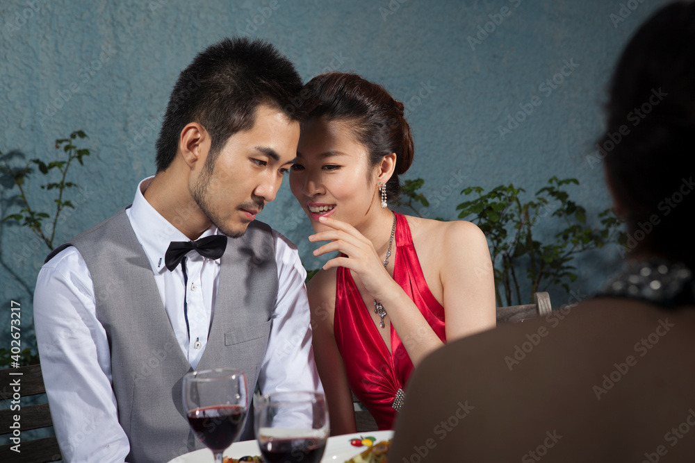 Four people sit together for dinner and chat