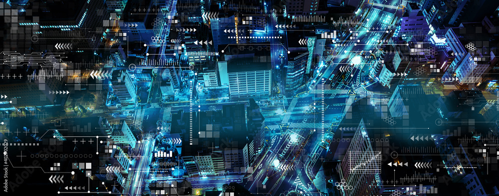 Technology screen with aerial view of urban city at night