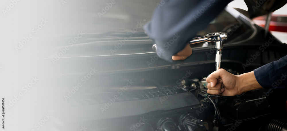 Car service, repair, maintenance concept. Auto mechanic working in garage.