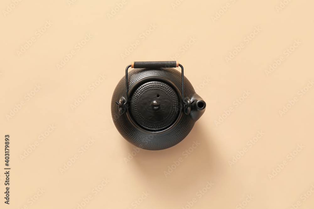 Teapot on color background, top view