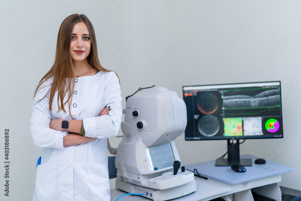 Female radiologist stands near monitor with teating results. Modern equipment in up to date clinic.