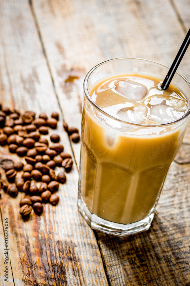 iced coffee with beans for cold summer drink on wooden background