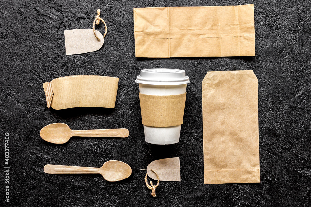 breakfast take away with paper bags on dark table background top view mock up