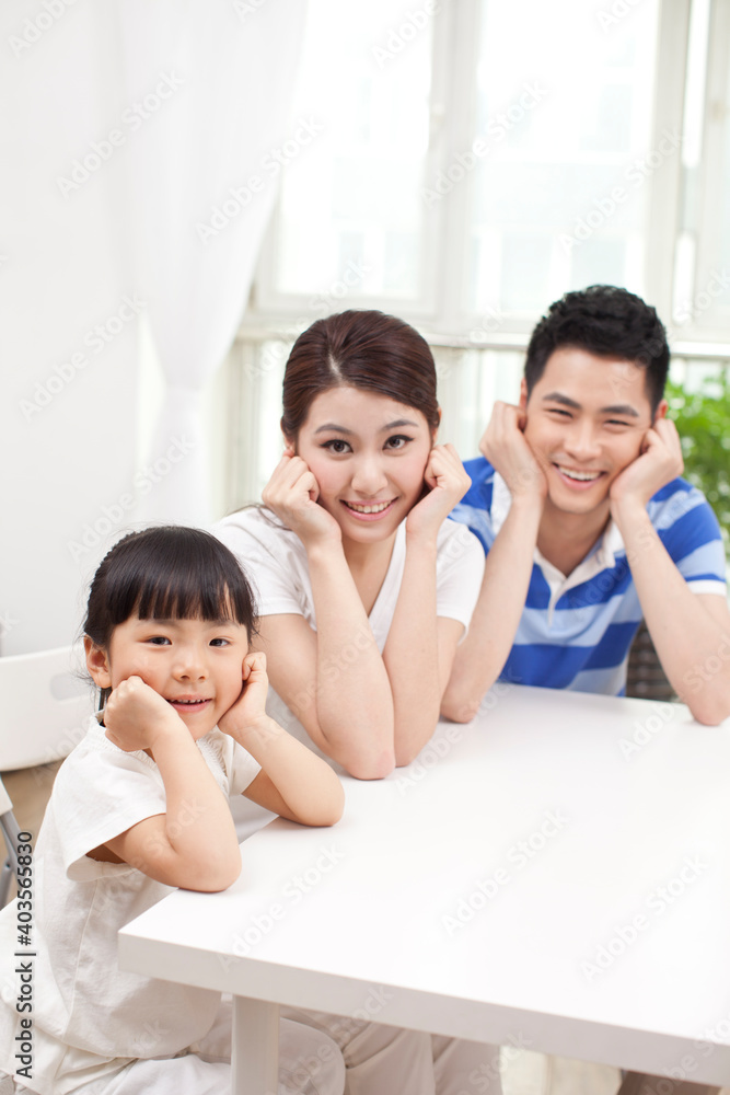 Happy family of three in the living room 