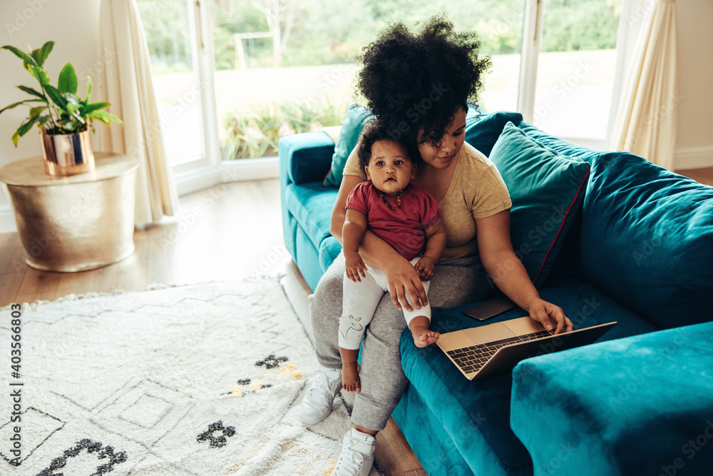 Mother with baby working from home