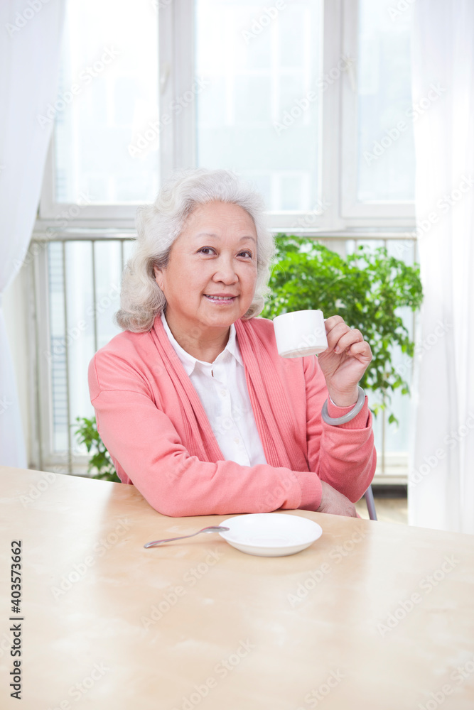 一位拿着茶杯的老年妇女