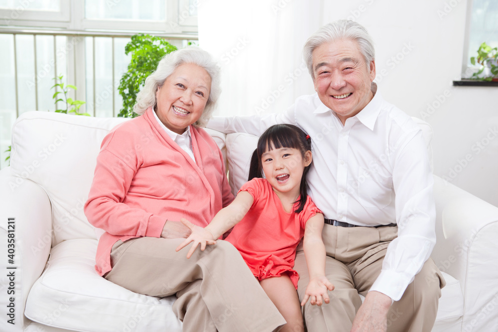 Happy grandparents and grandchildren are playing in the living room 