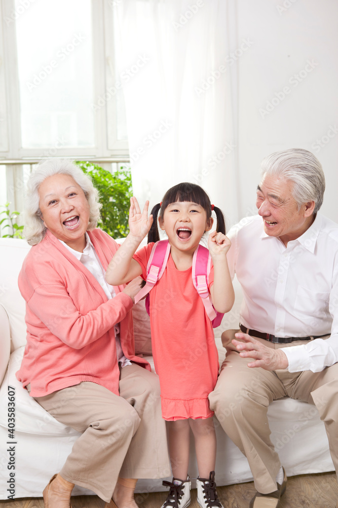 Happy grandparents and grandchildren are playing in the living room 