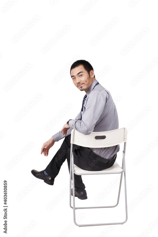 A cheerful young business man sitting posture