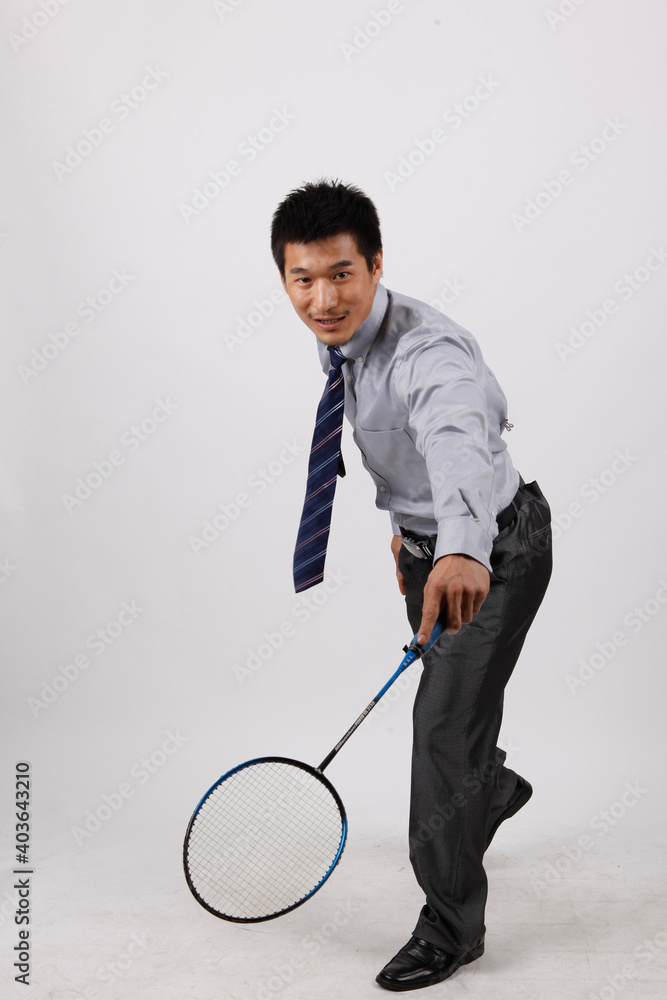 A business exercising with man playing badminton