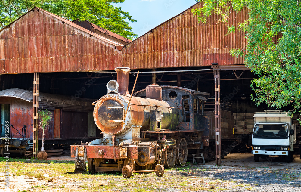 Rusty steam locomotive in a depot in Asuncion, Paraguay