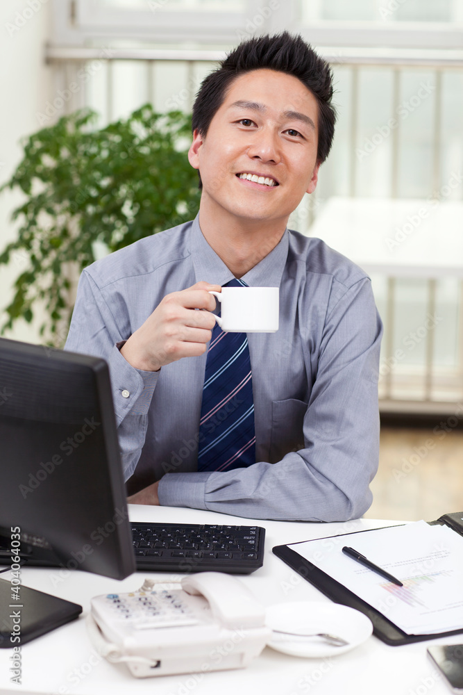 Close-up of a businessman using a laptop in an office