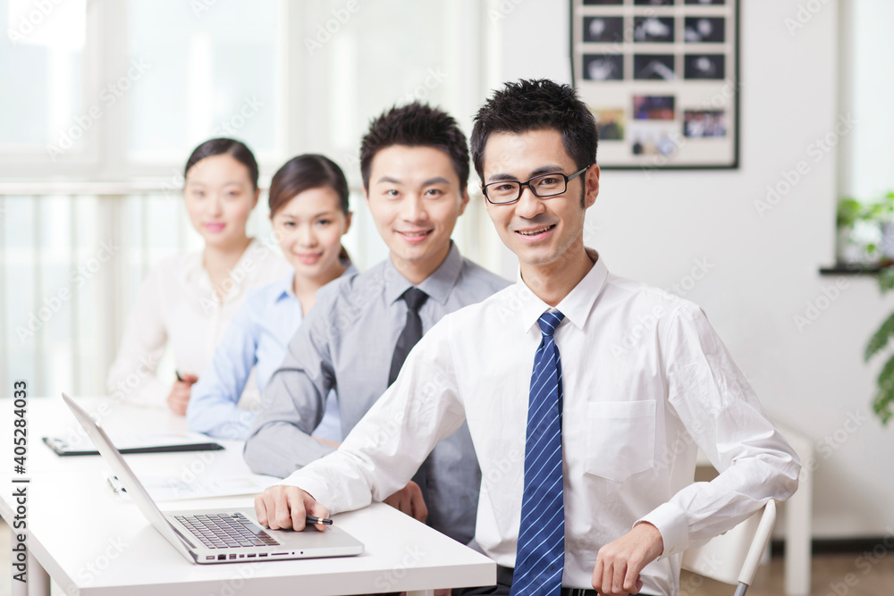 Group of business people sitting at conference table 