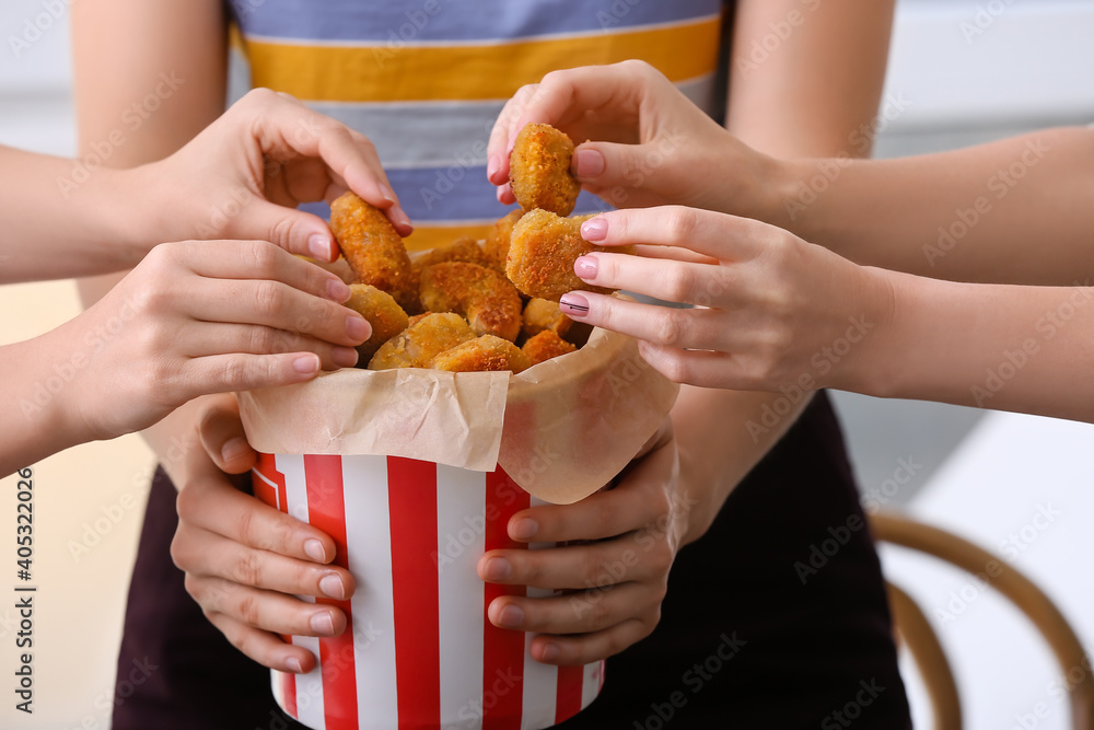 Women with bucket of tasty nuggets, closeup