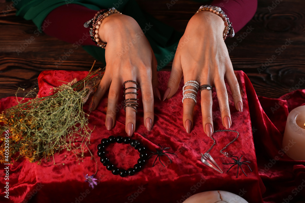 Fortune teller reading future at table