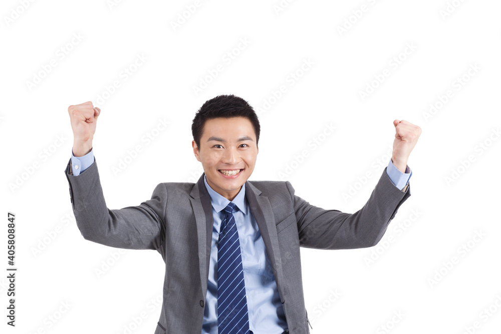 Portrait of young businessman holding up fists