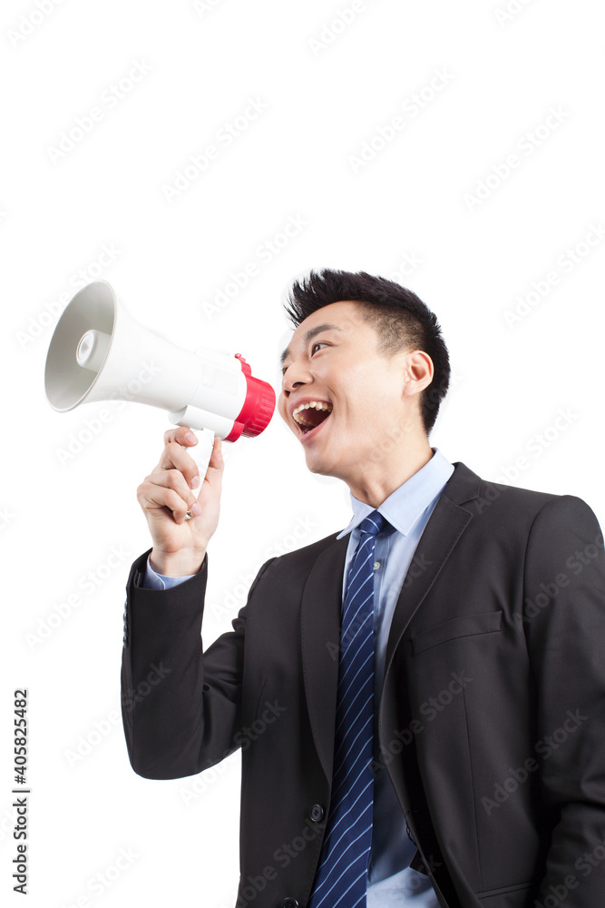 Portrait of young businessman shouting into Megaphone,close-up