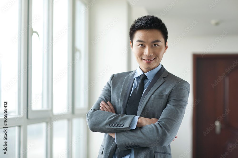 Portrait of young business man in corridor