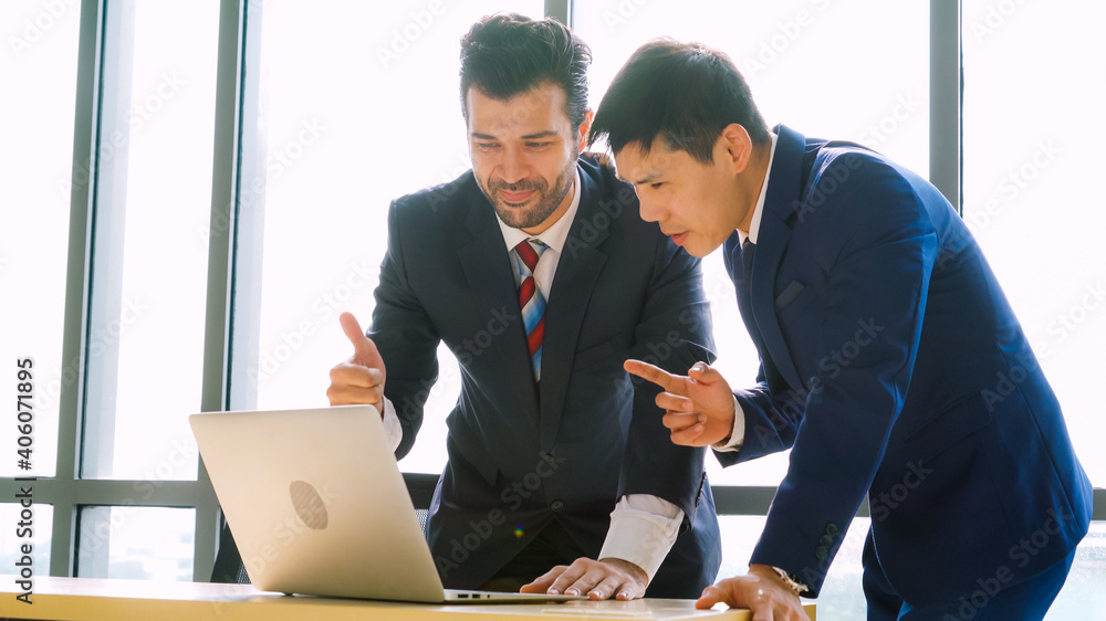 Two business people talk project strategy at office meeting room. Businessman discuss project planni