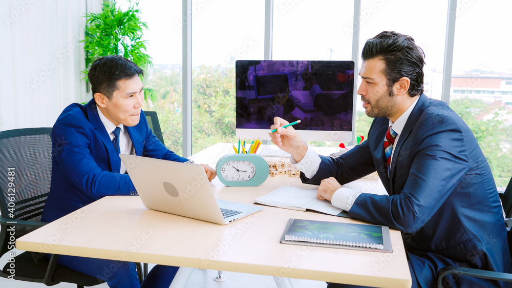 Two business people talk project strategy at office meeting room. Businessman discuss project planni