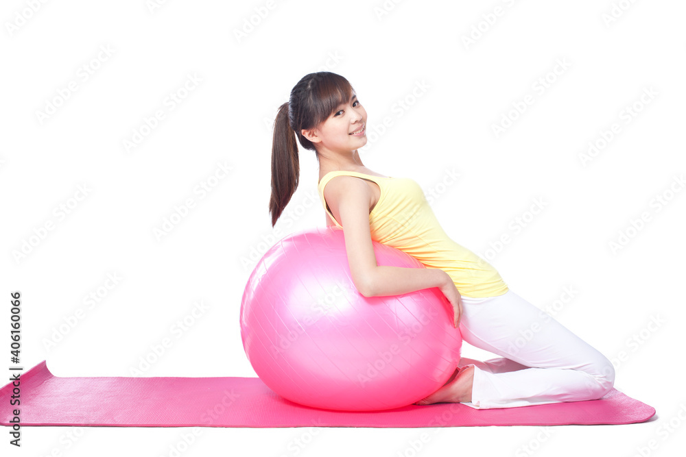 Portrait of woman resting against exercise ball