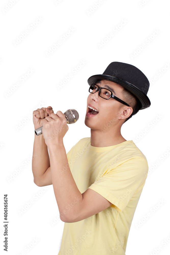 Studio portrait of young man singing into microphone