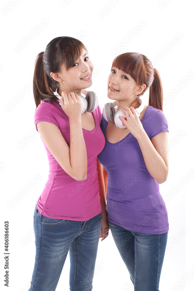 Portrait of two female friends weating earphone