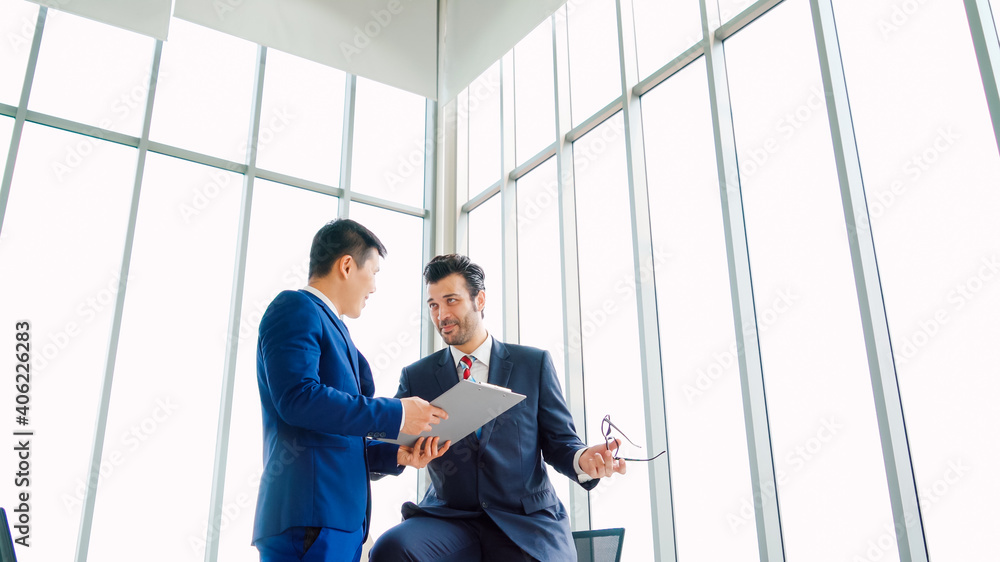 Two business people talk project strategy at office meeting room. Businessman discuss project planni