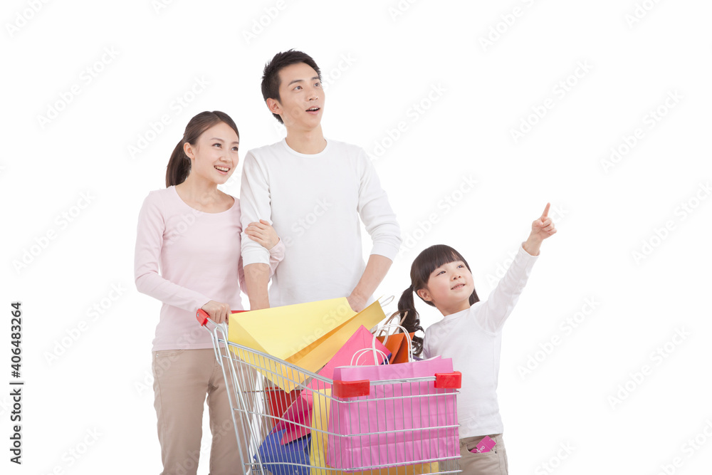 Portrait of daughter with parents ,pushing shopping cart,looking away