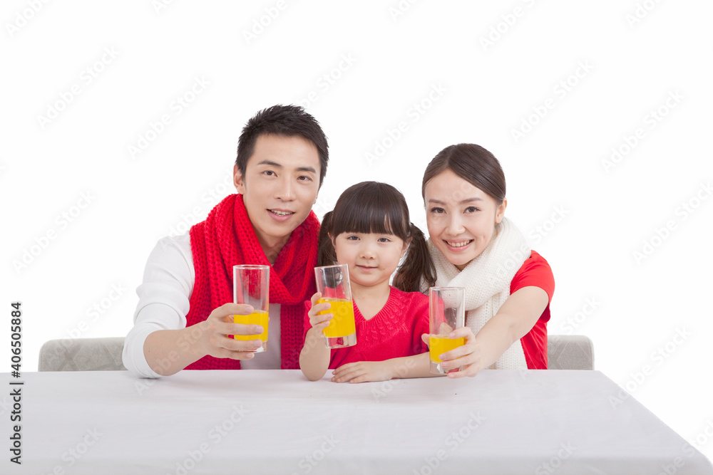 Portrait of daughter with parents holding fruit juice cups