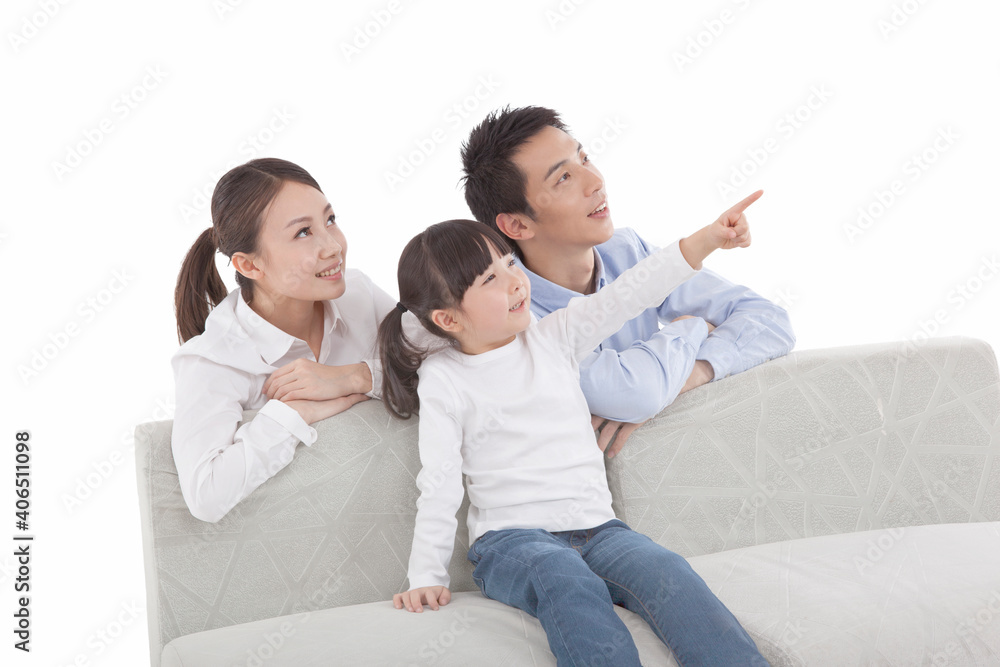 Portrait of daughter with parents,looking away,daughter pointing