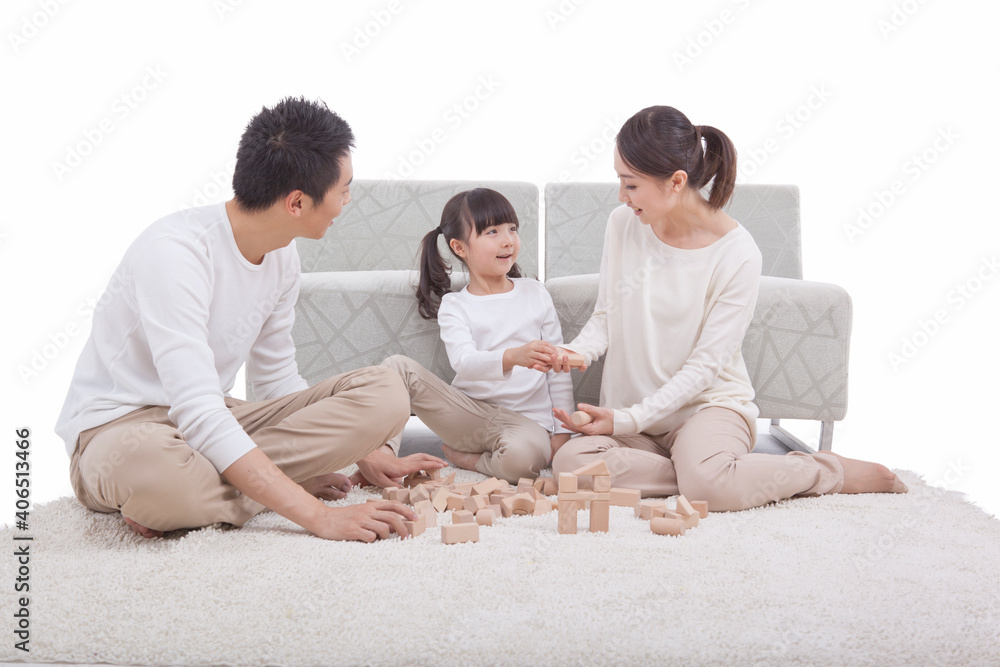 Portrait of daughter playing building blocks with parents