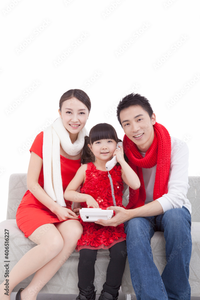 Portrait of daughter paying New Year call on telephone 