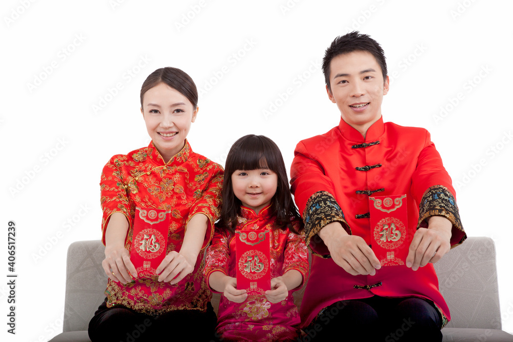 Portrait of daughter with parents with red envelopes,in Tang suits