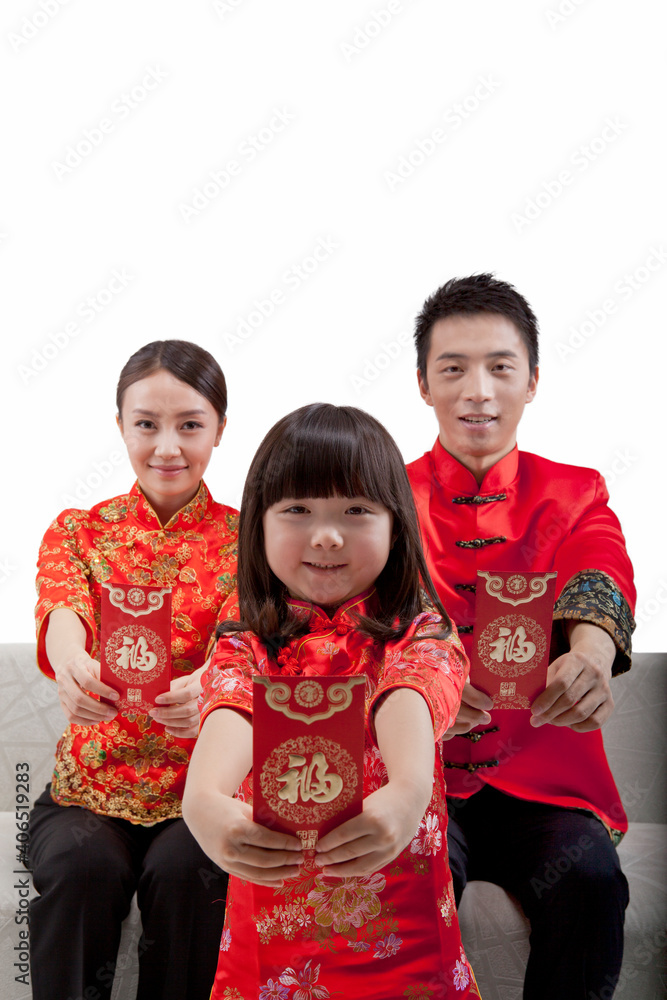 Portrait of daughter with parents holding red envelopes,in Tang suits