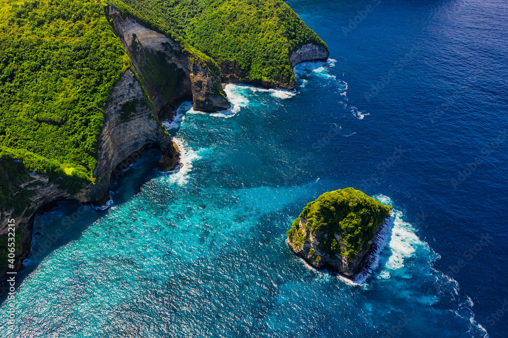 Waves and rocks as a background from top view. Blue water background from top view. Summer seascape 