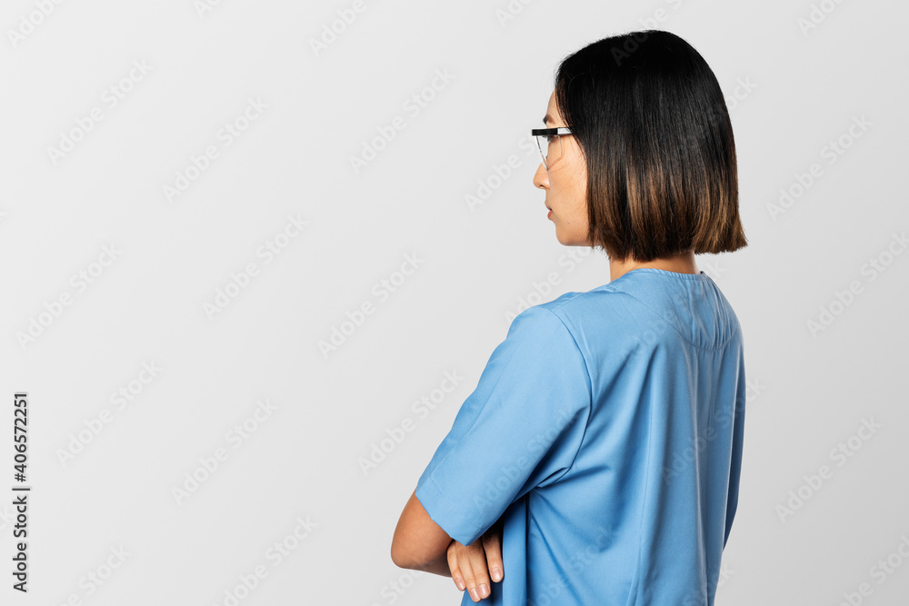 Rear view Asian doctor in blue medical uniform